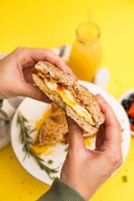 a person holding a sandwich