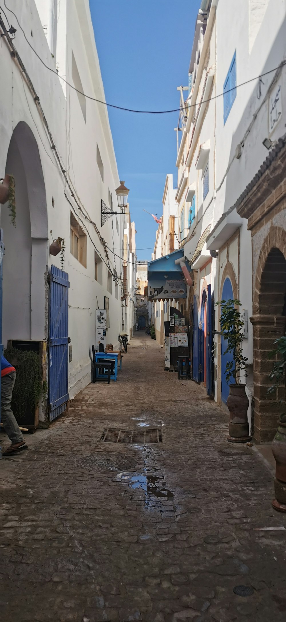 a cobblestone street with buildings on both sides