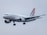 A commercial airplane bearing the Croatia Airlines branding is captured in mid-flight against a cloudy gray sky. The aircraft has a sleek white body with distinctive red and blue checkered patterns on the vertical stabilizer.