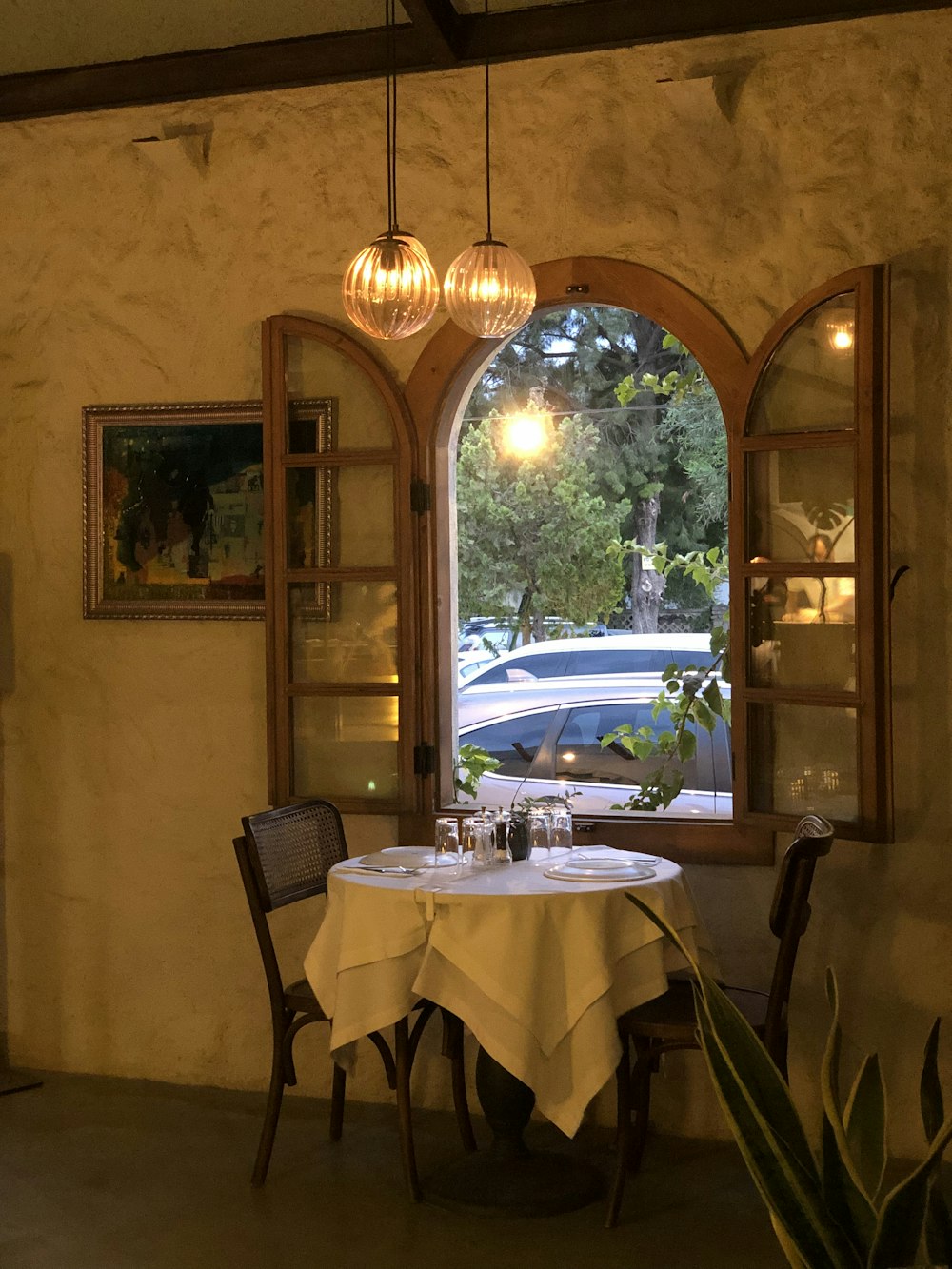 a dining table with a chandelier above it