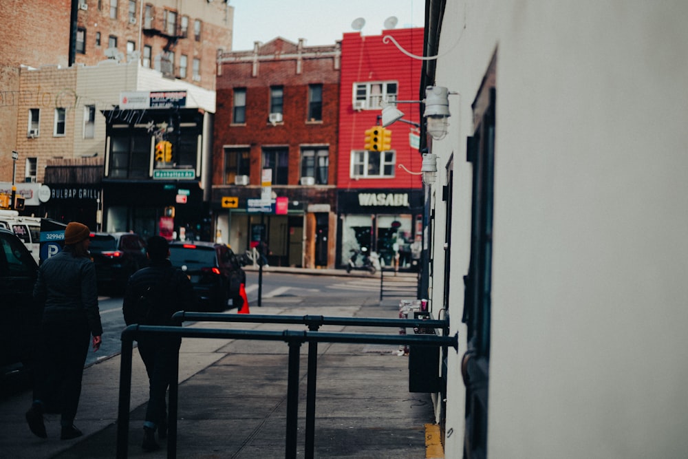 a group of people walking on a sidewalk