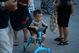 A group photo of happy children and families with their new adaptive tricycles.