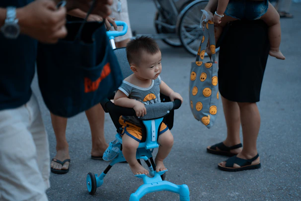 A group of toddlers lined up, each on their colorful Tinywheelz bikes, ready for an outdoor adventure.