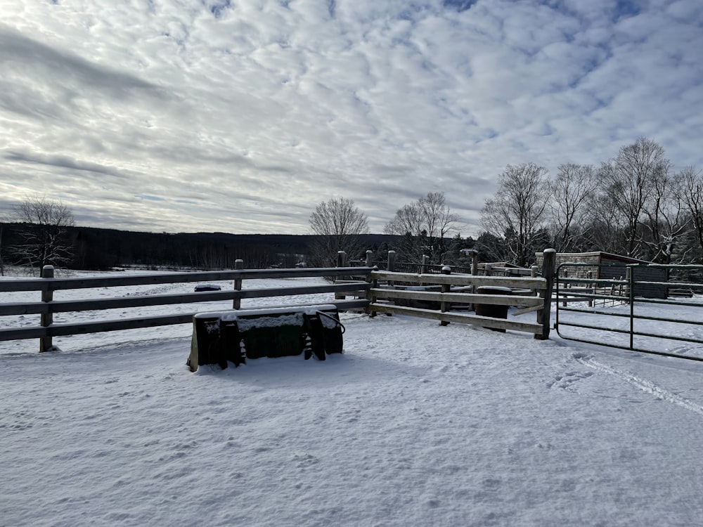 a bench in a snowy field