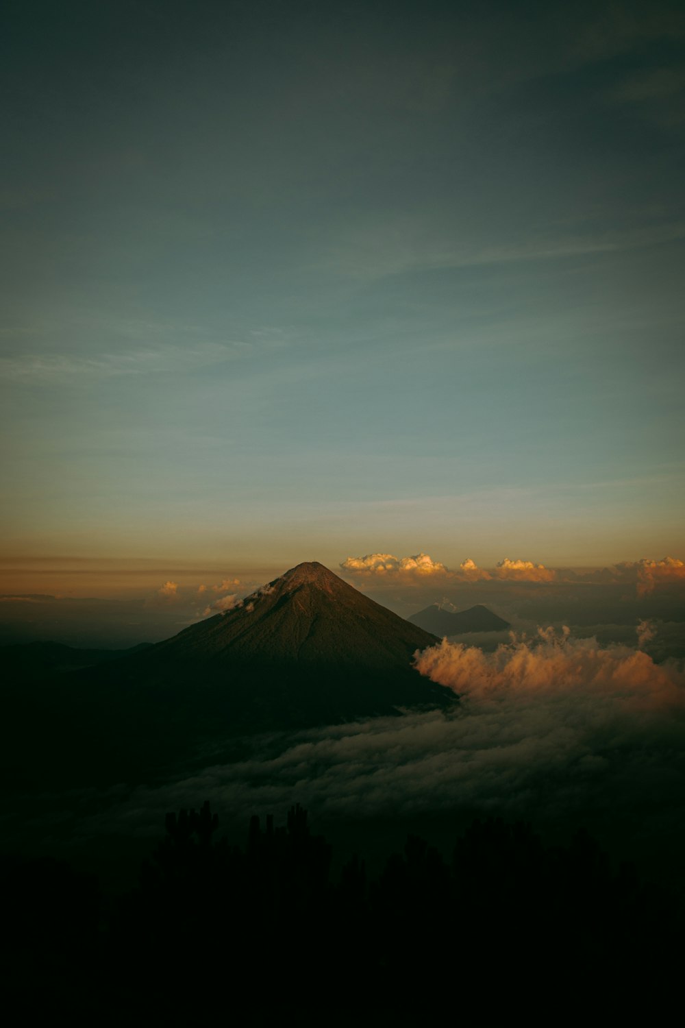 a mountain with a foggy sky