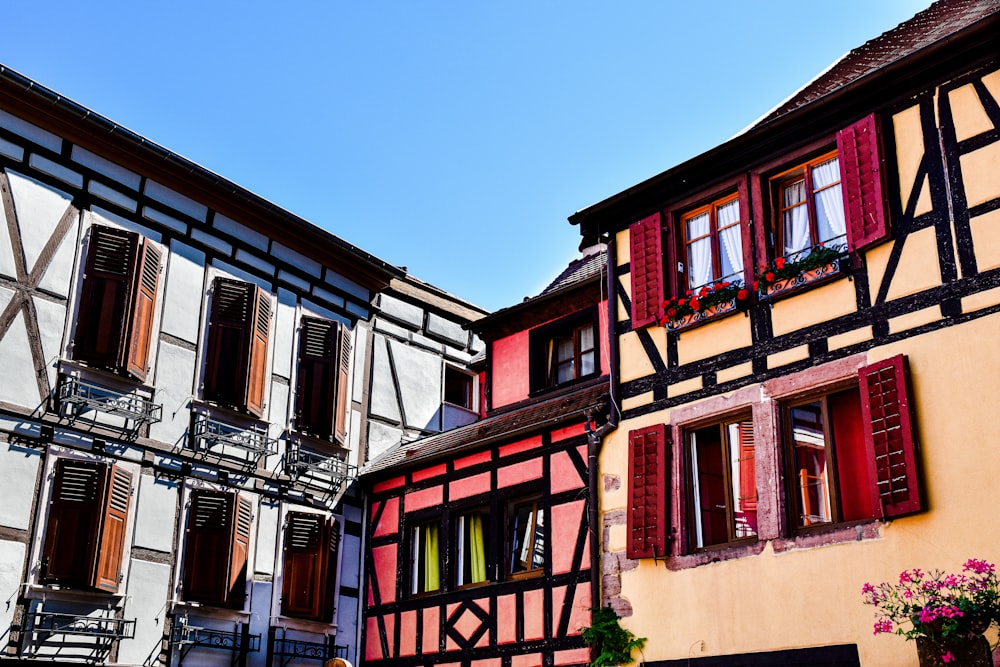 a row of buildings with red shutters