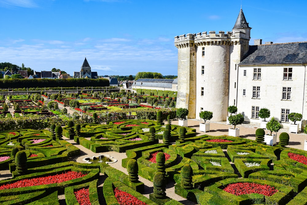 a large white building with a garden in front of it with Château de Villandry in the background