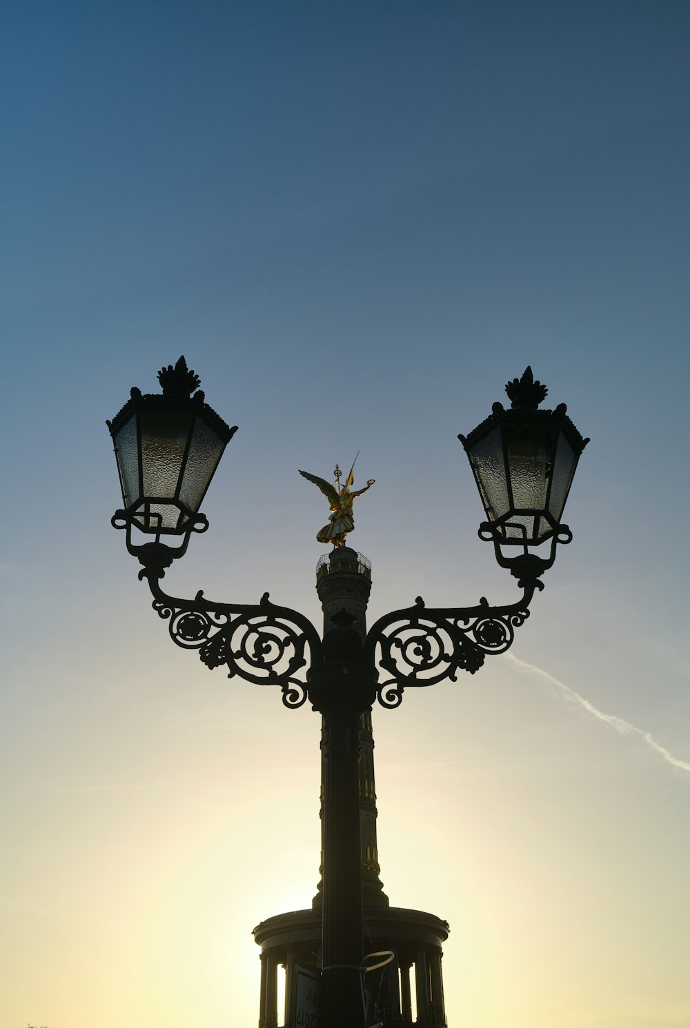 a light post with a statue on top