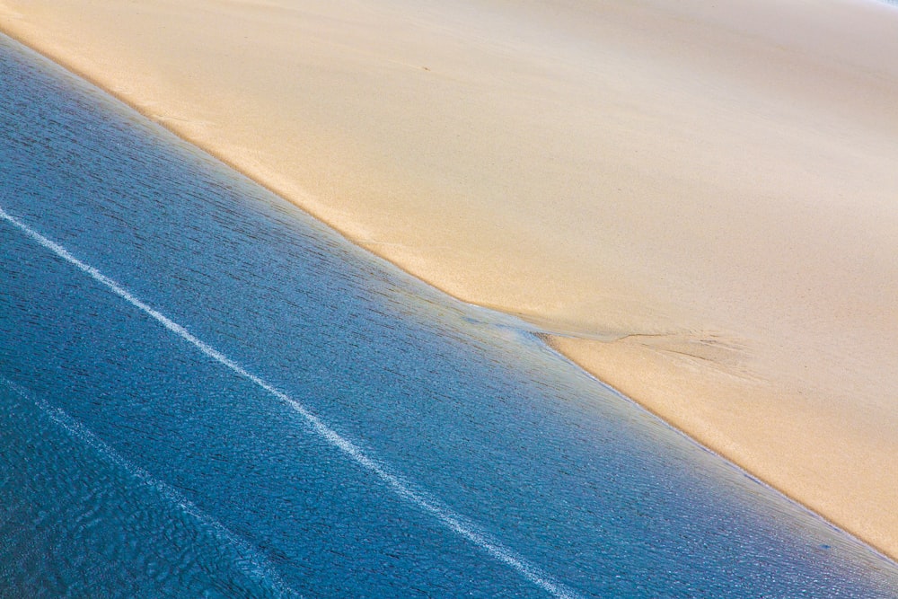 a blue and white line on a sandy beach