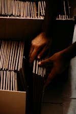 a pair of hands holding a wire