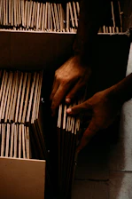 a pair of hands holding a wire