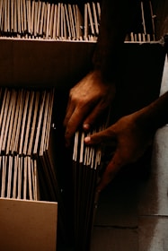 a pair of hands holding a wire