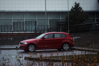 a red car parked in front of a building