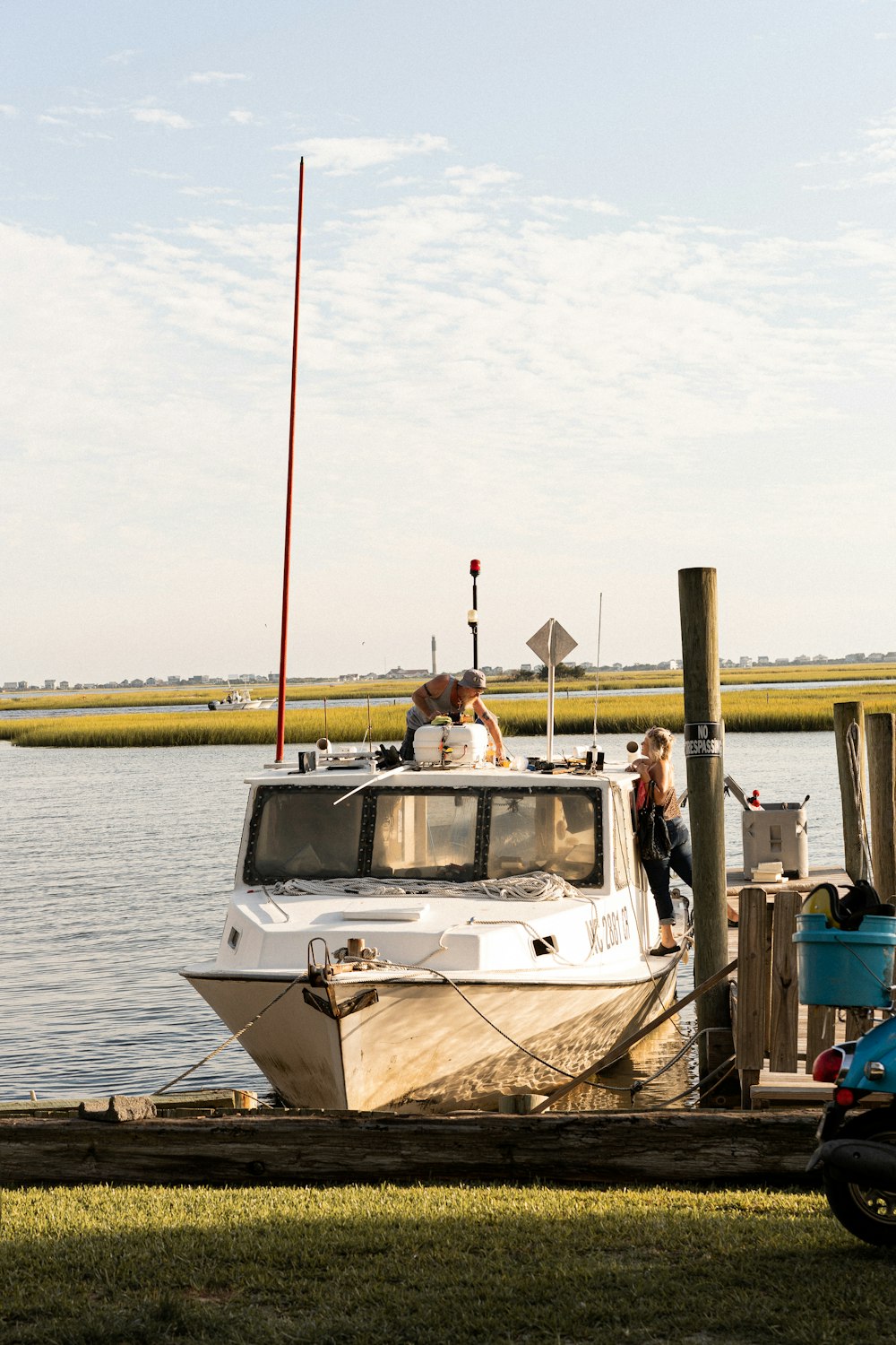 a group of people standing next to a boat on a dock