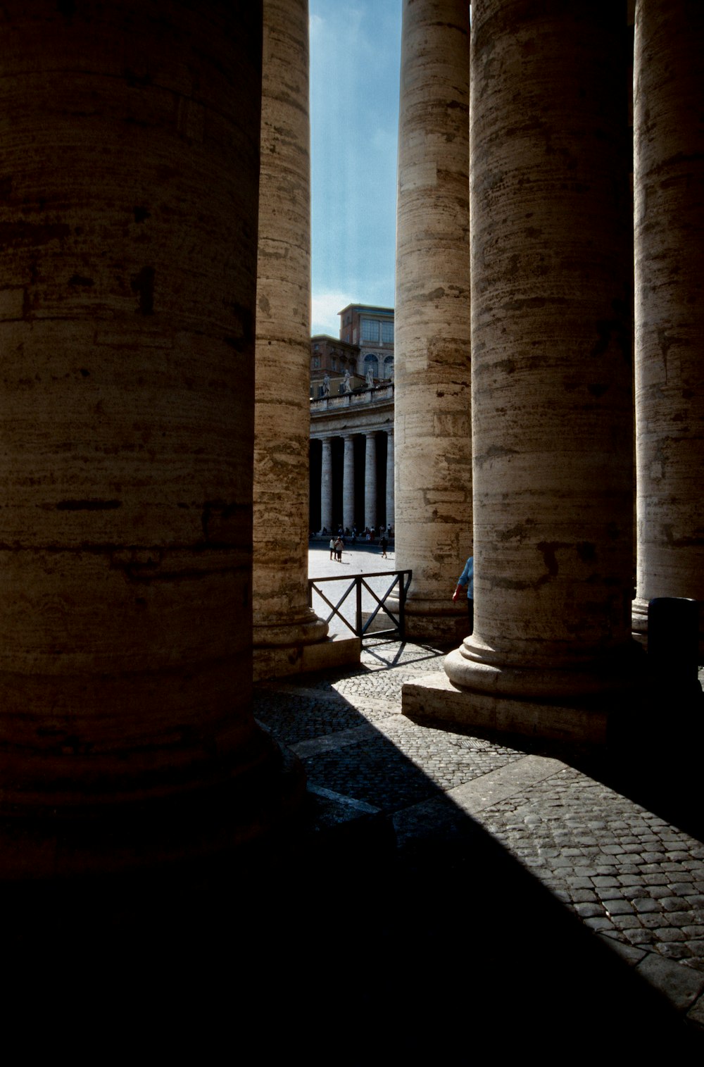 a stone walkway between two stone pillars