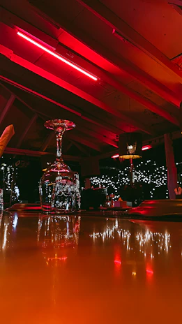 Flash Bar Pro resting on a sleek bar counter with colorful nightlife ambiance in the background.