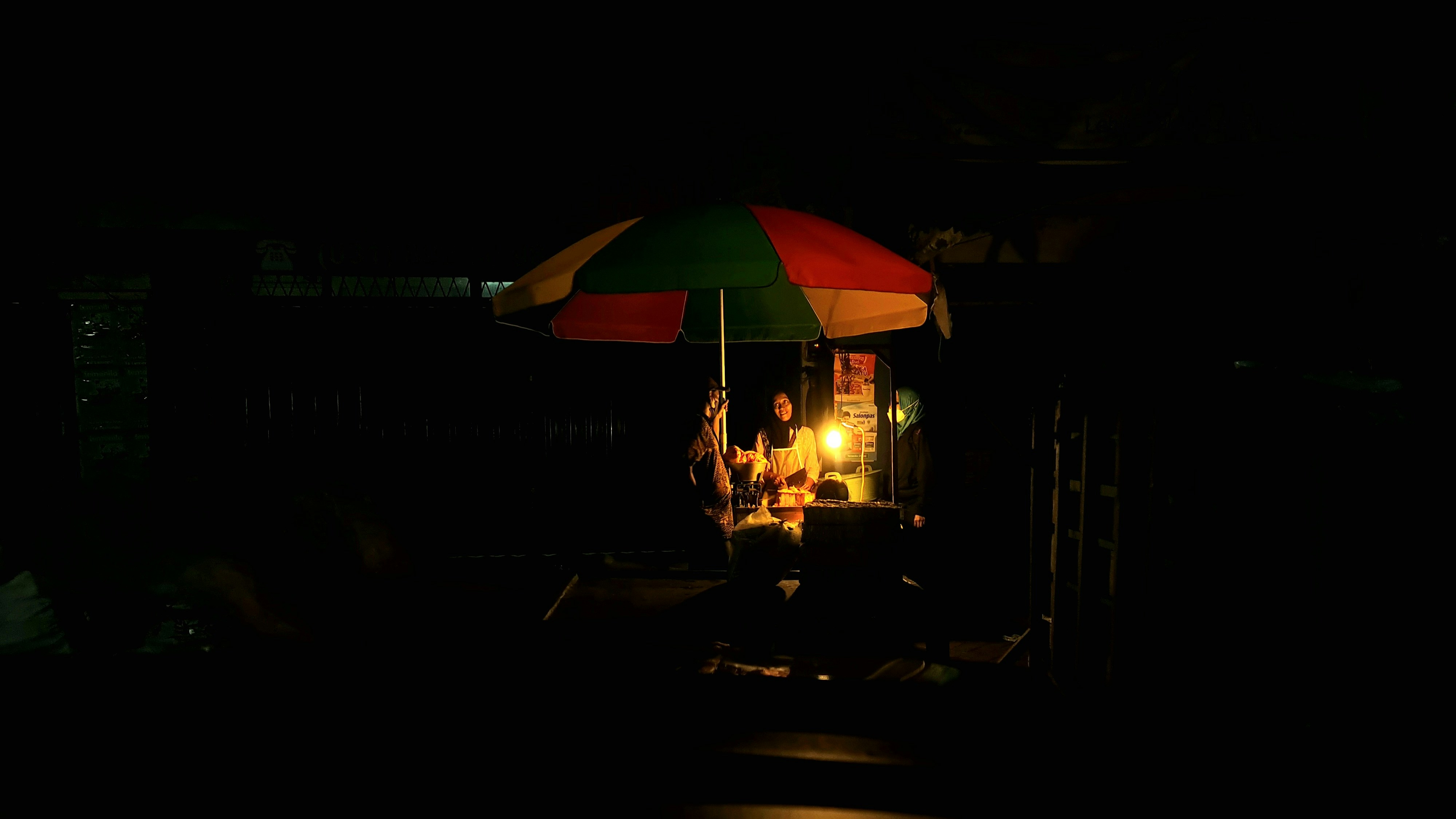 a group of people under an umbrella