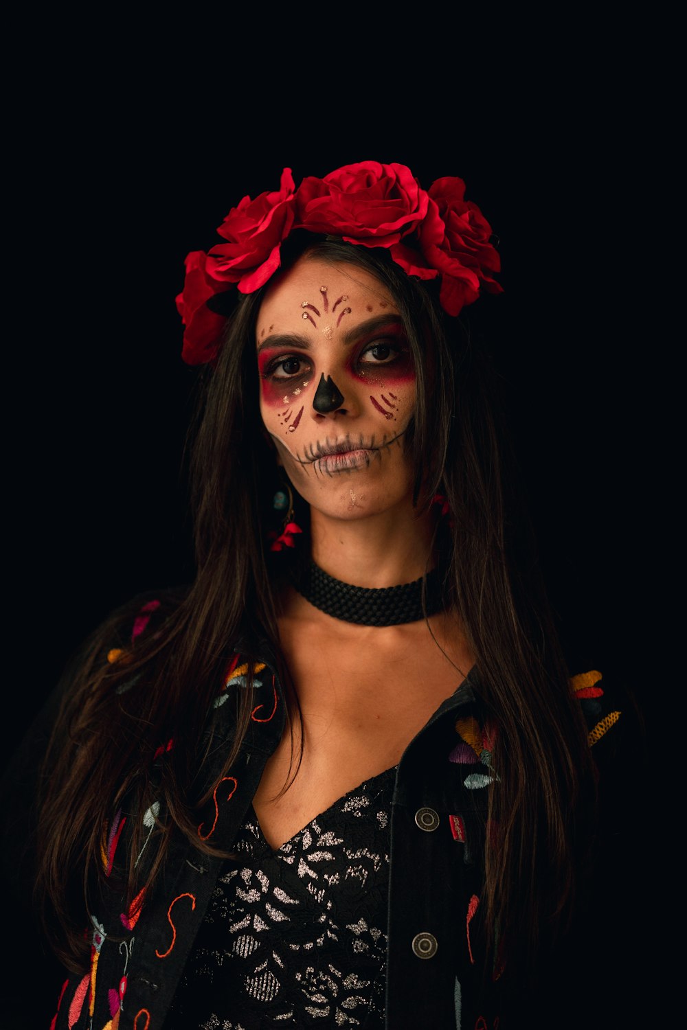 a woman with red hair and a black shirt with a black and white face paint