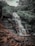 A group of hikers enjoying a waterfall in Chapada dos Veadeiros.