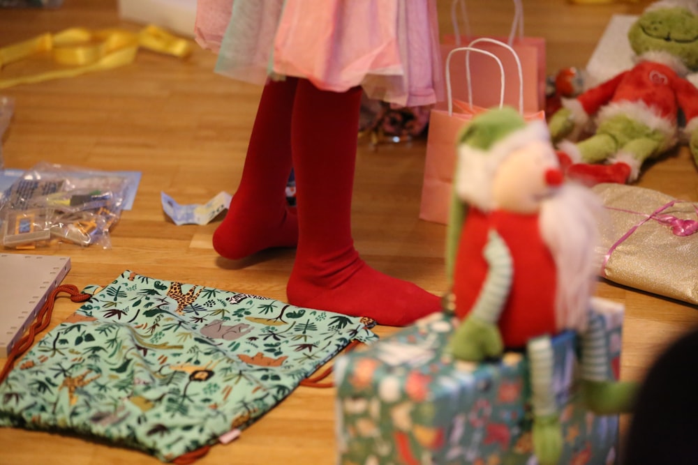 a child's feet in red socks and red boots