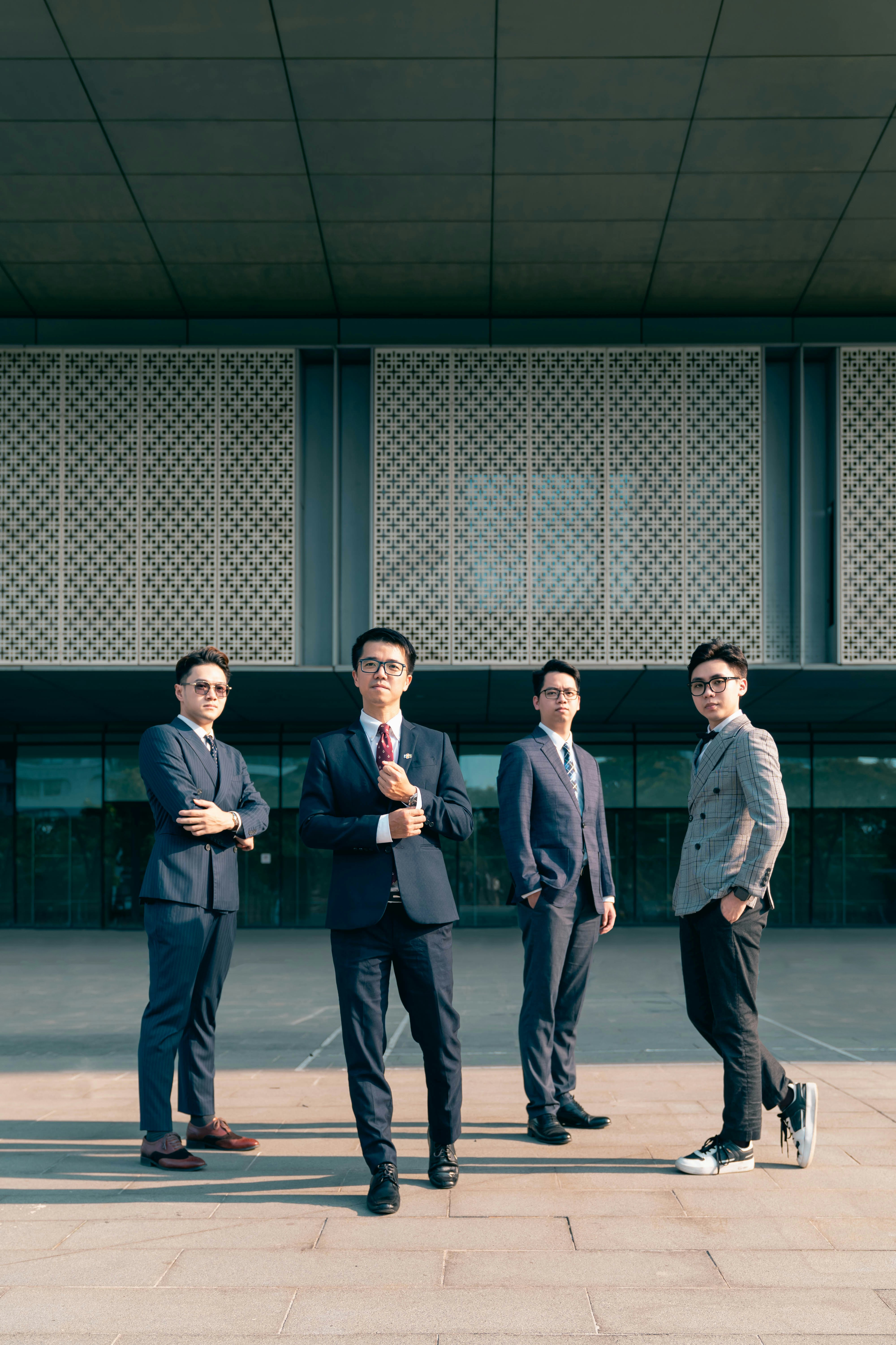 a group of men standing in front of a building