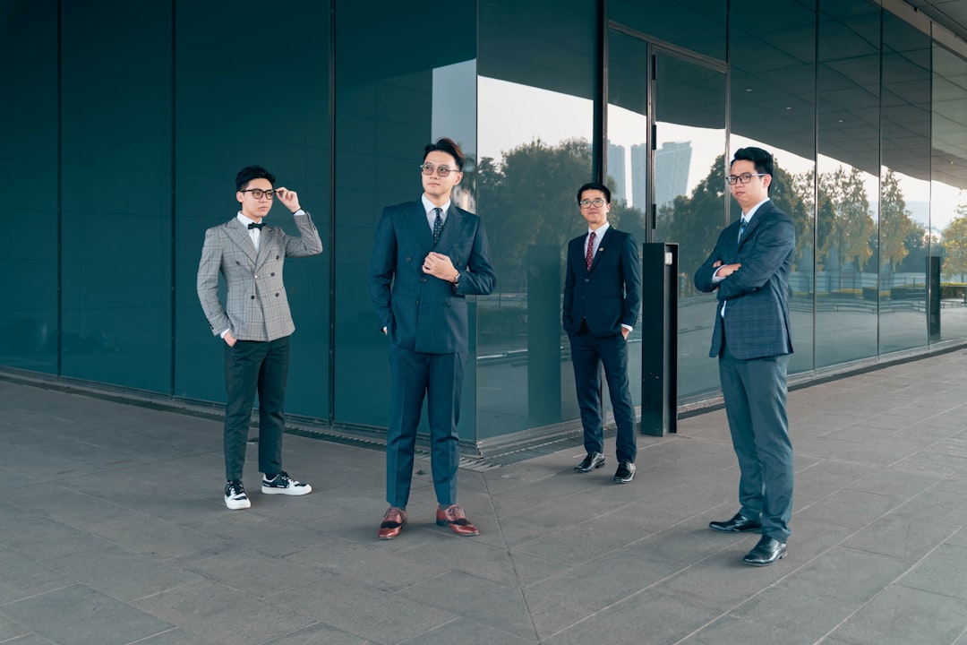 a group of men standing in front of a glass wall,