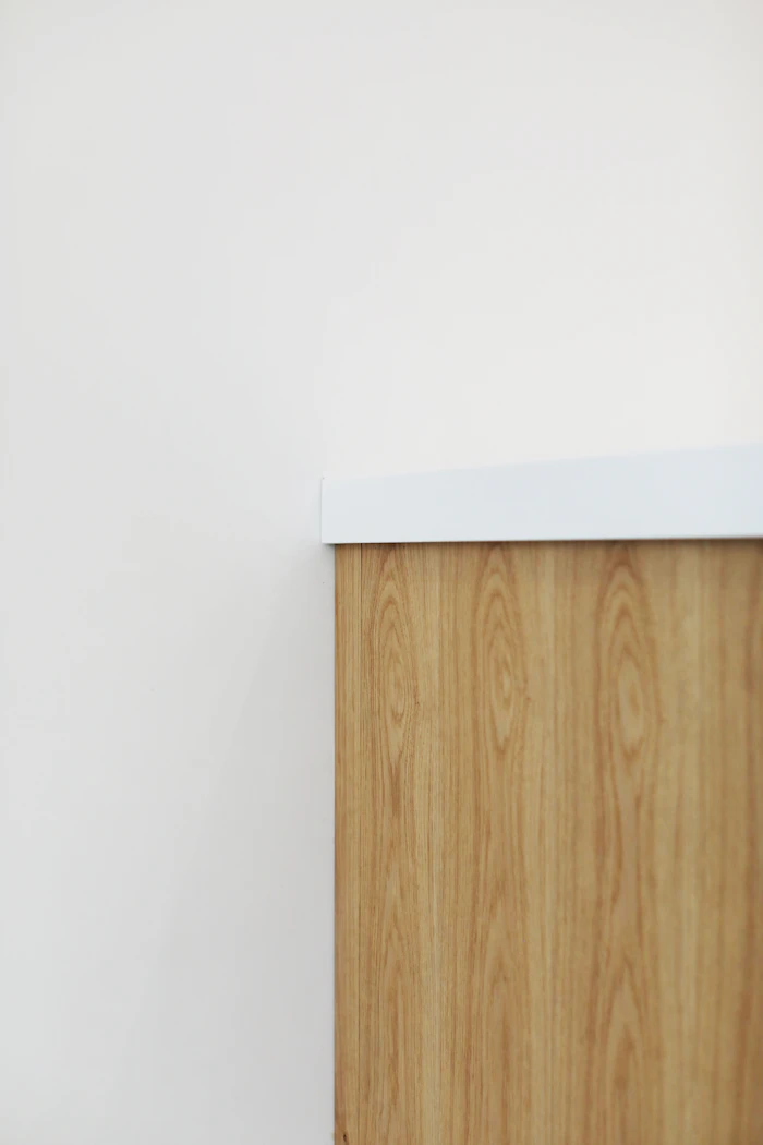 Wooden cabinet against a white wall