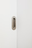Modern face ID lock installed on a minimalist cream-colored door frame.
