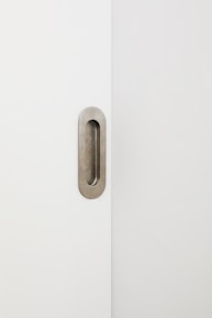 Sleek black and gold high-security door lock installed on a minimalist white door.