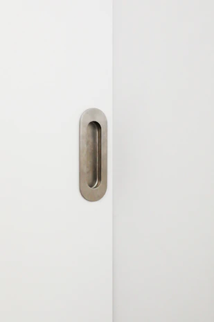 Close-up of a sleek white door frame installed in a minimalist interior.