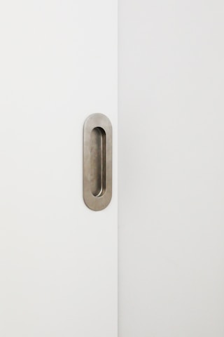 Sleek black and gold high-security door lock installed on a minimalist white door.