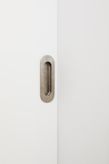 A variety of contemporary door handles displayed on a minimalist white background.