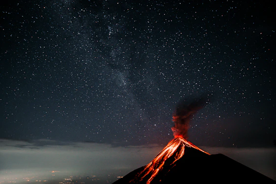 A vibrant 3D model of a volcanic eruption under a starry night sky, showcasing intricate details and cosmic elements.