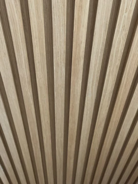 Interior wall featuring warm-toned wood-plastic composite panels adding texture and depth.