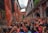 A lively community event in a historic courtyard with people enjoying local performances.