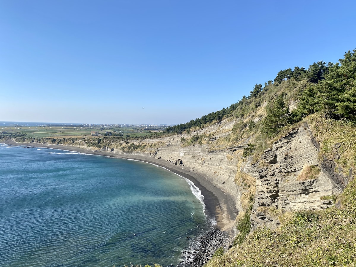 Jeju Seongsan Ilchulbong sunrise peak with crater rising from sea