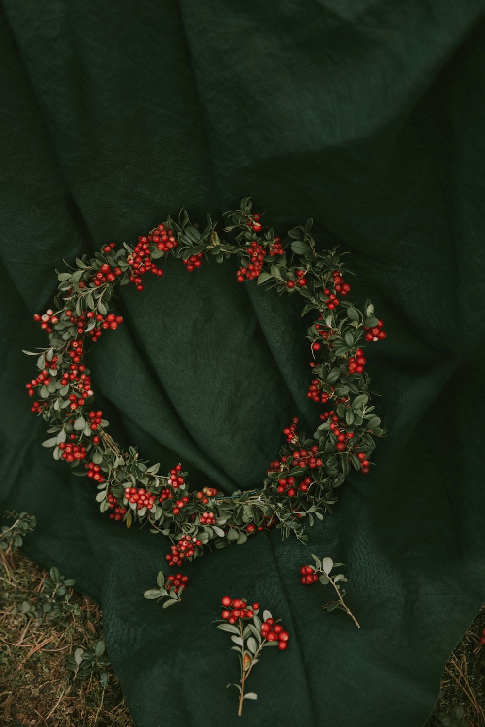 a green blanket with red flowers