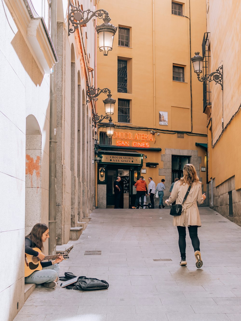 a person sitting on the sidewalk