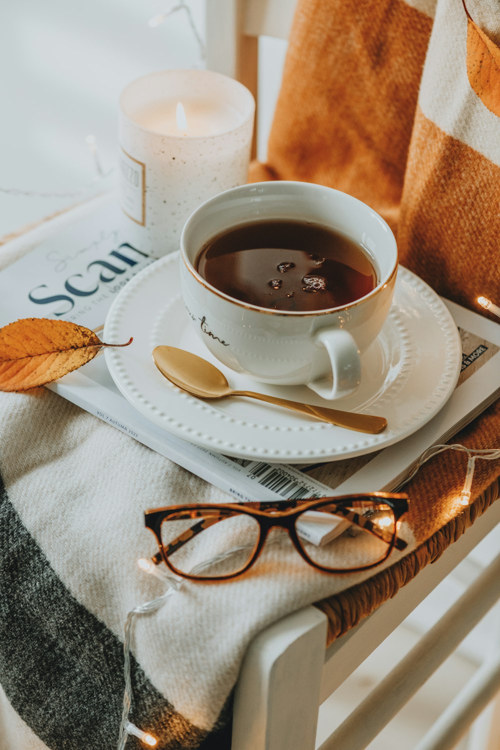 a cup of coffee and a spoon on a tray