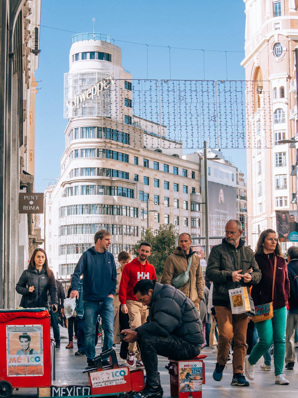 a group of people posing for a photo in front of a building