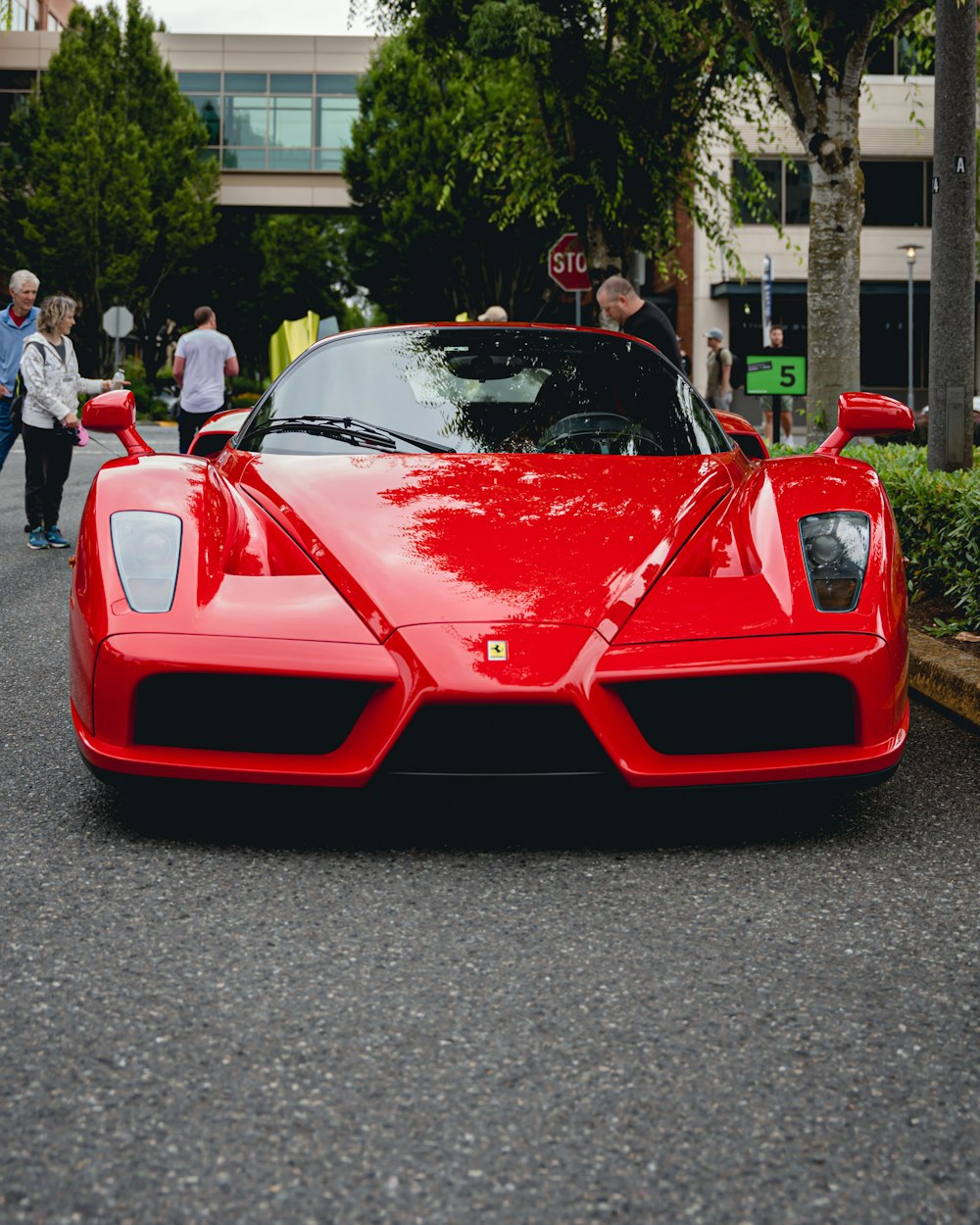 a red sports car parked on the side of a road