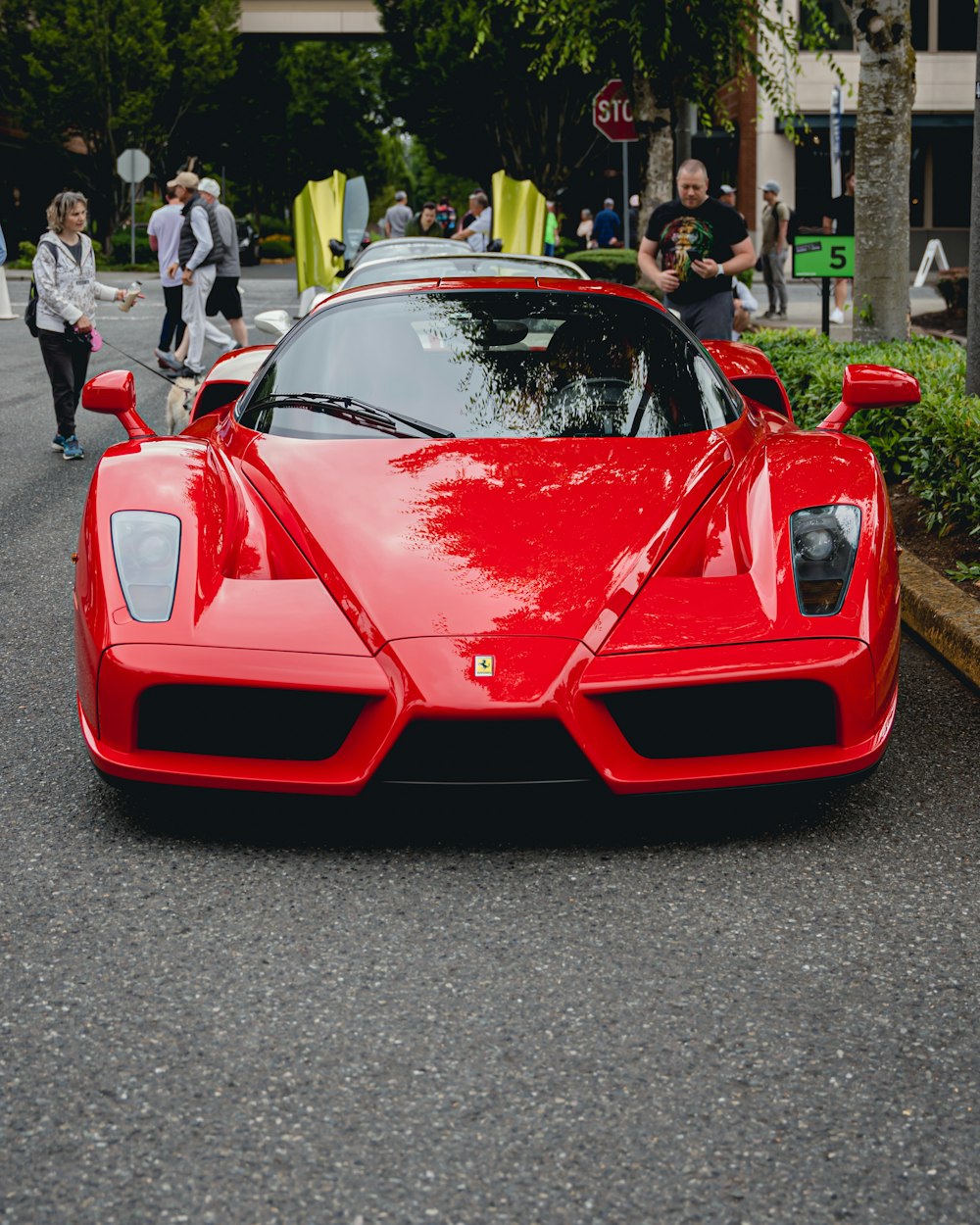 a red sports car parked on the side of a road