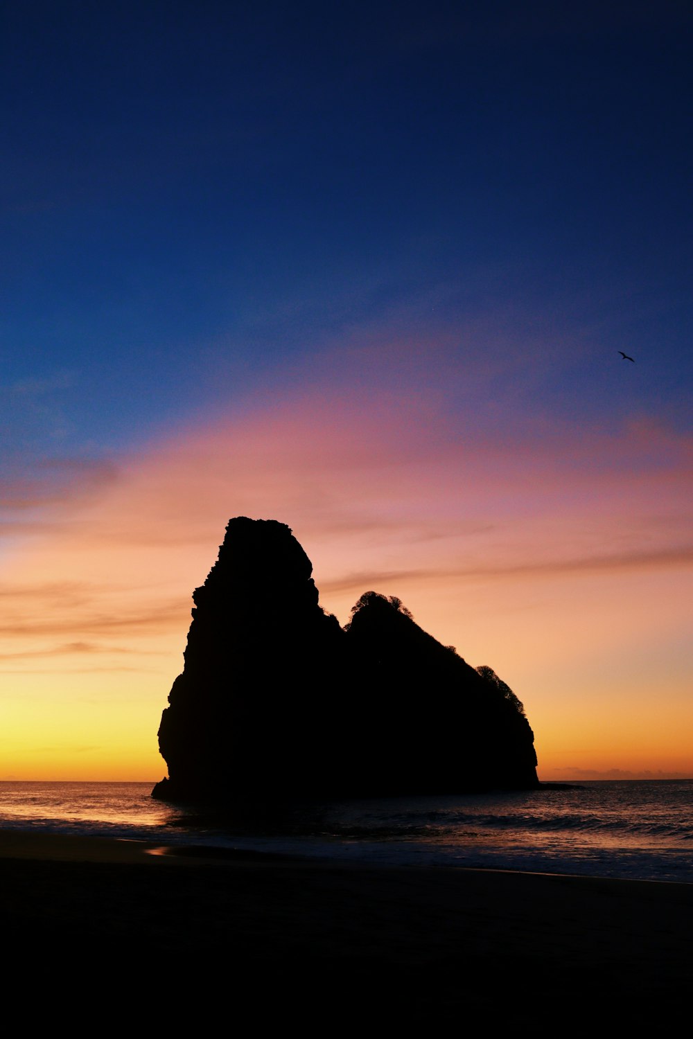 a rock formation on a beach