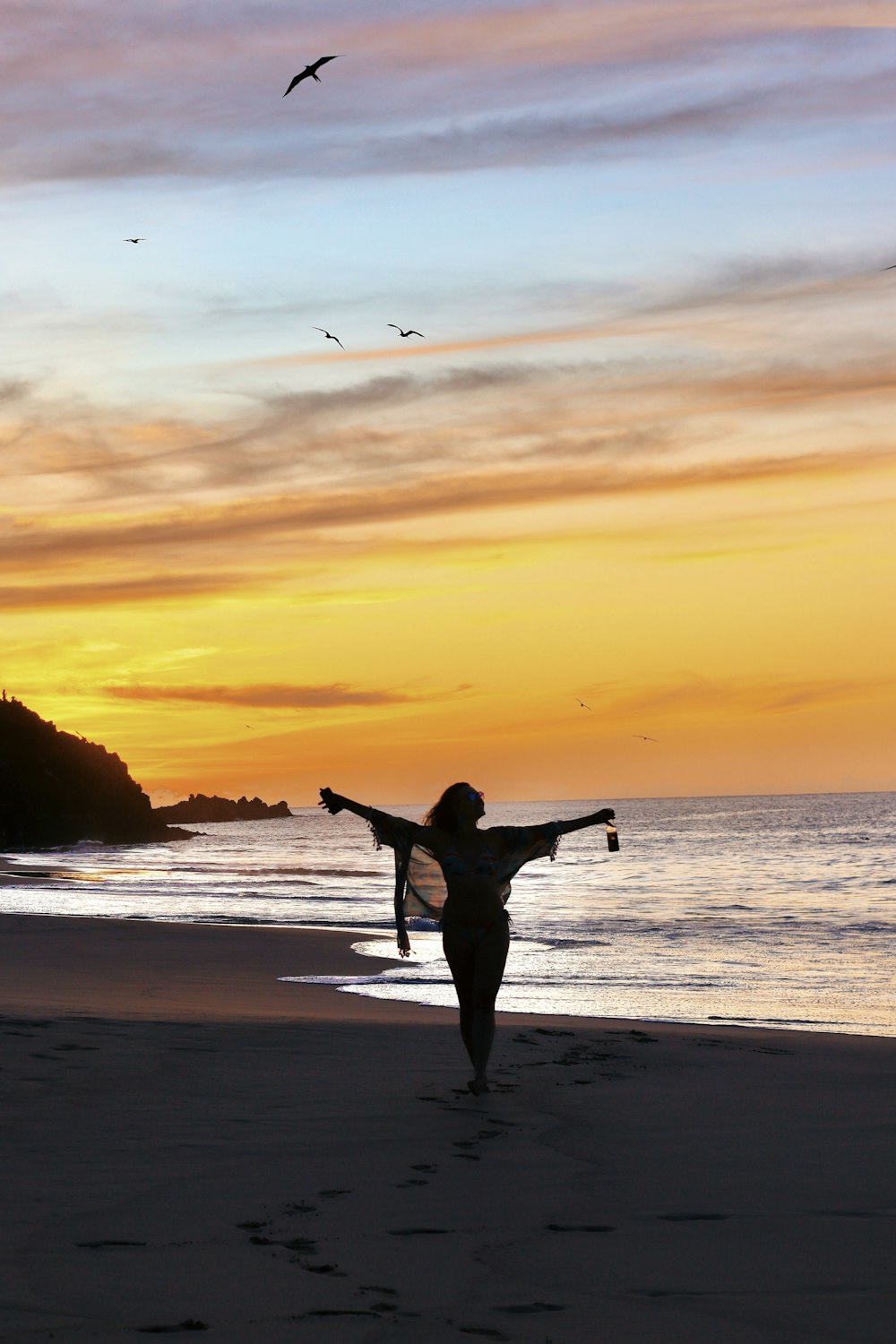 a person holding a surfboard on a beach