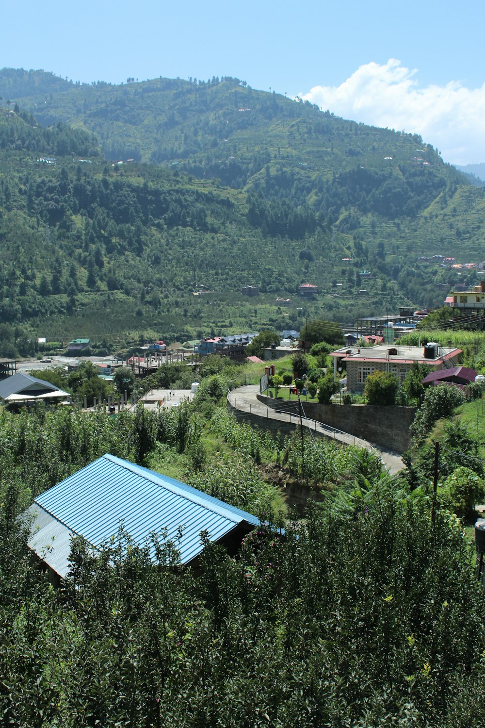 a large green landscape with buildings and trees