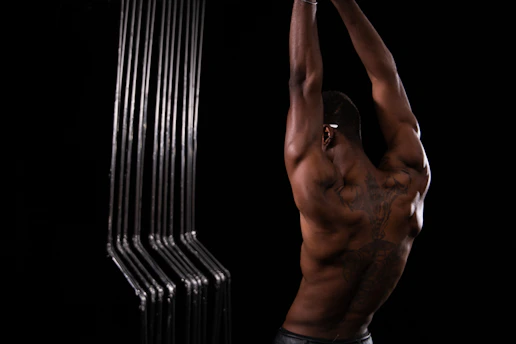 Close-up of a fitness athlete stretching muscles after a workout session.