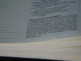 A close-up view of a book opened to a page with text discussing the theme of wisdom and youth. The text is printed in black ink on white paper, with a focus on a paragraph titled 'Advancement is meaningless'.