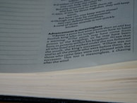 A close-up view of a book opened to a page with text discussing the theme of wisdom and youth. The text is printed in black ink on white paper, with a focus on a paragraph titled 'Advancement is meaningless'.