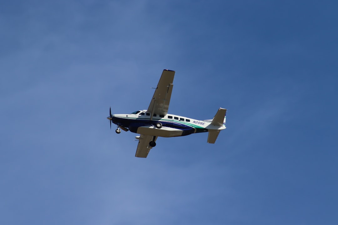 a small airplane flying in the sky,