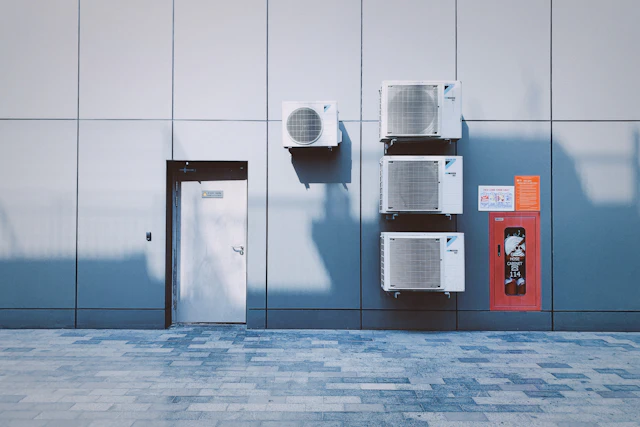 Technician installing a high-efficiency air conditioning system